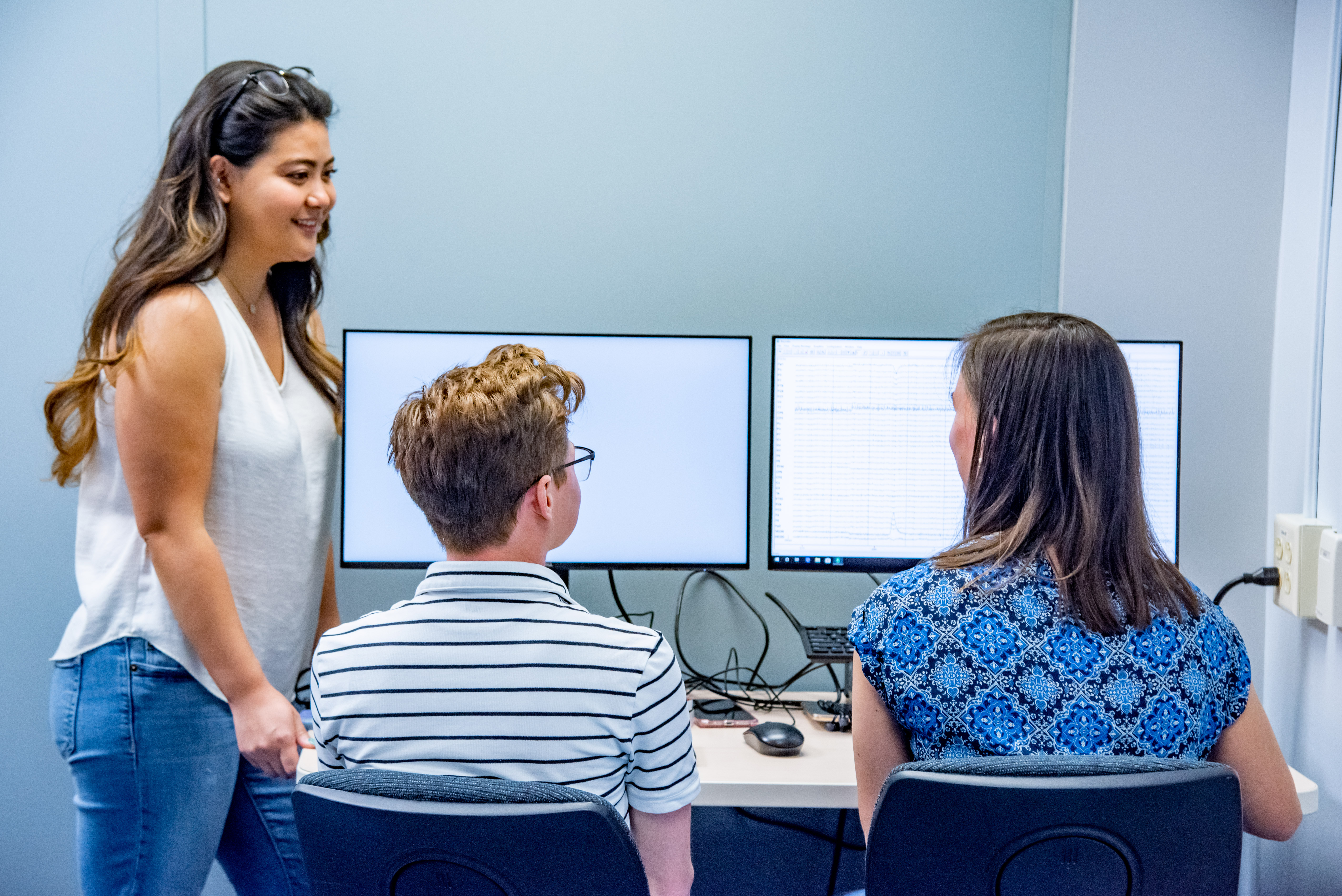 Grad student Megan Nakamura with undergrads Mel Mallard and Madelyn Kloske monitoring EEG data