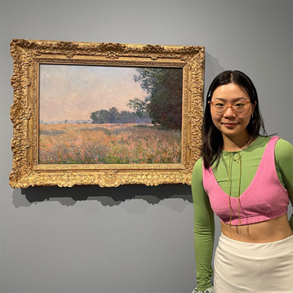 Image of Jian next to a painting